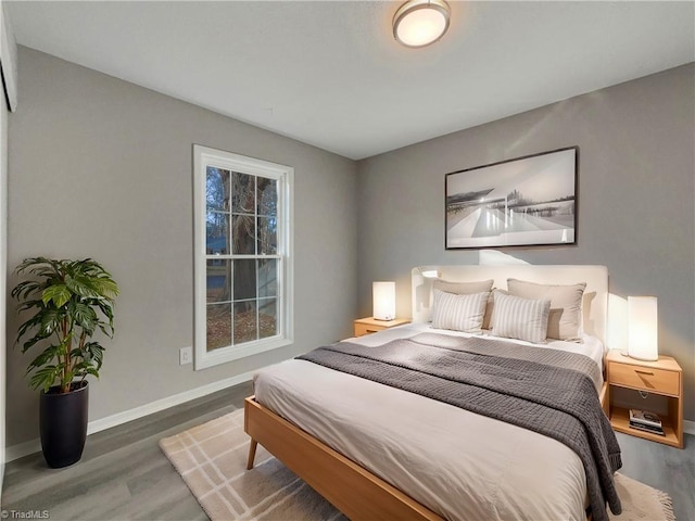 bedroom with dark hardwood / wood-style floors