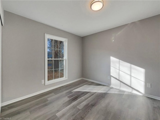 spare room with dark hardwood / wood-style flooring