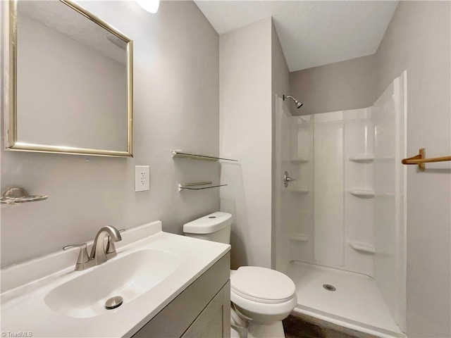 bathroom featuring vanity, toilet, and walk in shower