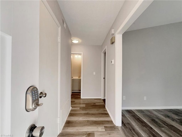 corridor with light hardwood / wood-style flooring