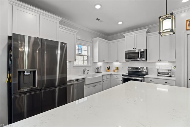 kitchen featuring tasteful backsplash, appliances with stainless steel finishes, a sink, and crown molding