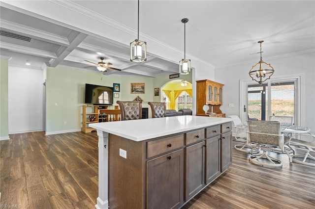 kitchen with hanging light fixtures, dark wood-style floors, visible vents, and open floor plan