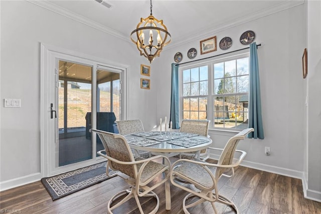 dining room featuring crown molding, visible vents, baseboards, dark wood finished floors, and an inviting chandelier