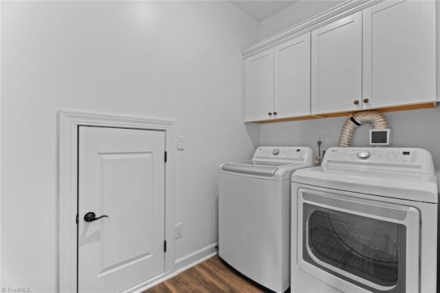 laundry room featuring cabinet space, baseboards, dark wood-type flooring, and washer and dryer