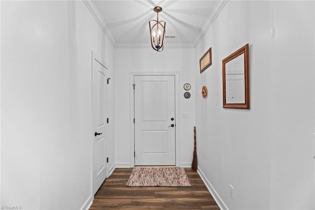 doorway to outside featuring dark wood finished floors, visible vents, an inviting chandelier, ornamental molding, and baseboards