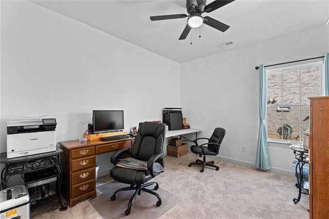 home office with carpet floors, a ceiling fan, visible vents, and baseboards