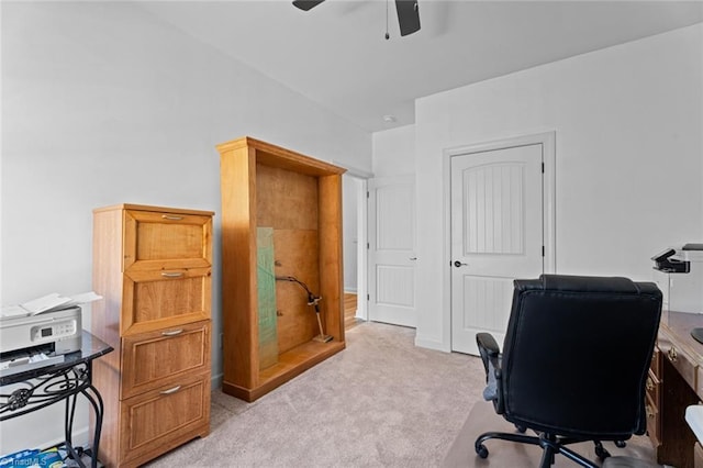 office area featuring ceiling fan, baseboards, and light colored carpet