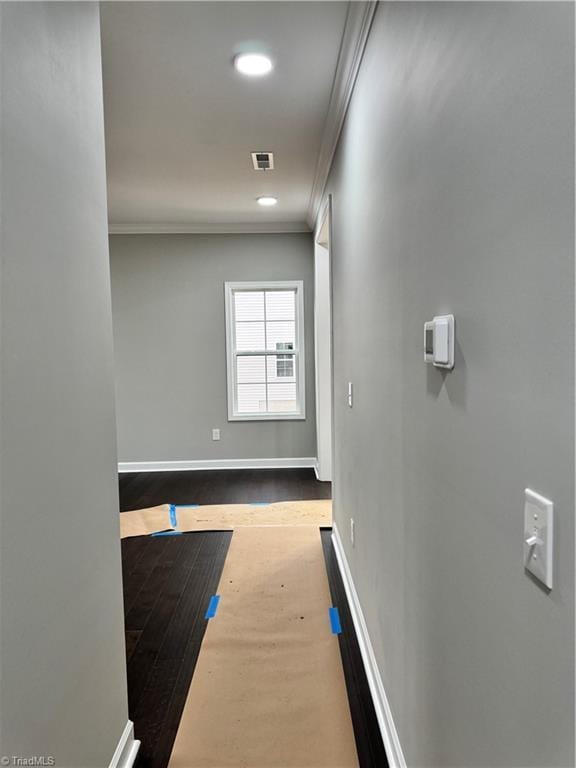 corridor with crown molding and hardwood / wood-style floors