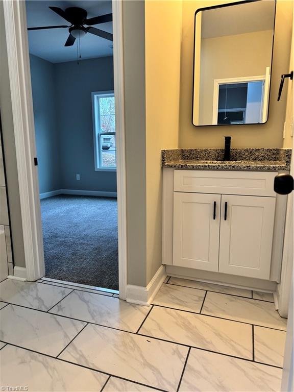 bathroom with ceiling fan and vanity