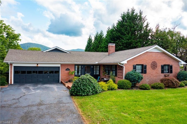 ranch-style house featuring a front lawn and a garage