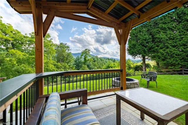 wooden deck with a lawn and a gazebo