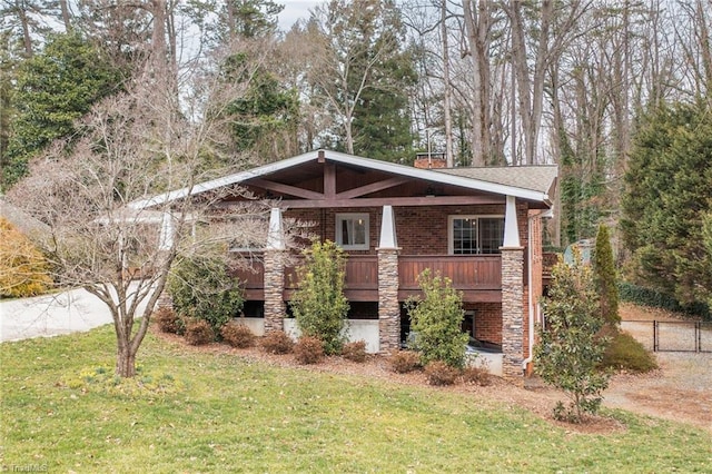 craftsman house featuring a front lawn, fence, brick siding, and a chimney