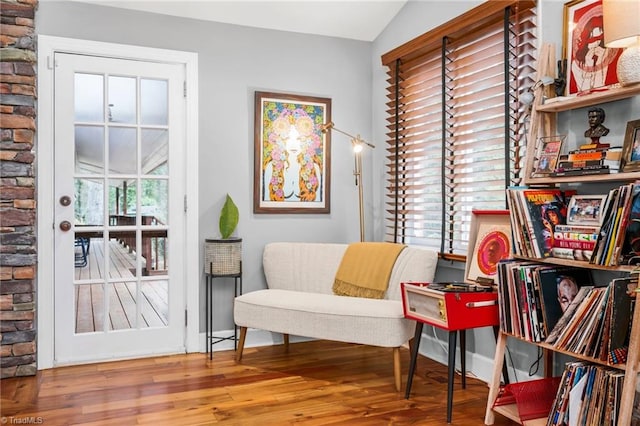 sitting room featuring vaulted ceiling, wood finished floors, and a wealth of natural light