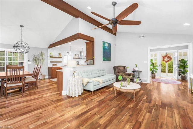 living room with a wealth of natural light, visible vents, and light wood-style flooring