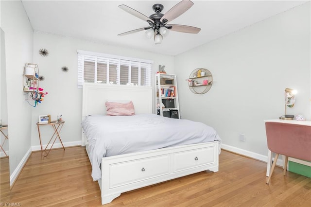 bedroom featuring ceiling fan, baseboards, and light wood-style flooring