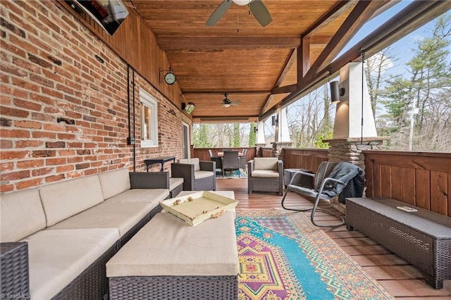 sunroom with a ceiling fan, vaulted ceiling with beams, and wood ceiling