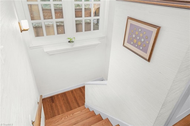 stairway with baseboards and wood finished floors