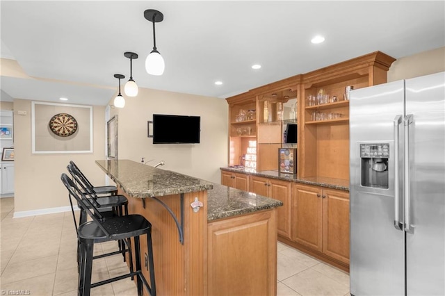 kitchen with open shelves, a kitchen island, dark stone counters, stainless steel fridge with ice dispenser, and light tile patterned floors