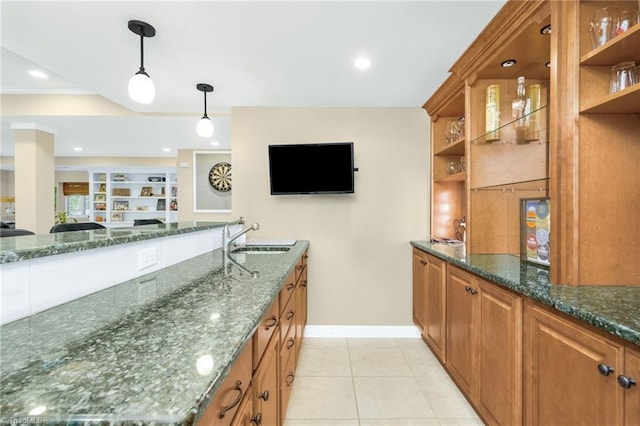 kitchen featuring a sink, open shelves, brown cabinets, and light tile patterned floors