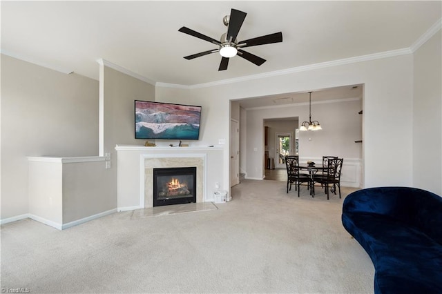 living area featuring crown molding, carpet floors, a ceiling fan, baseboards, and a fireplace