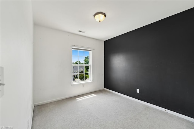 carpeted spare room with baseboards