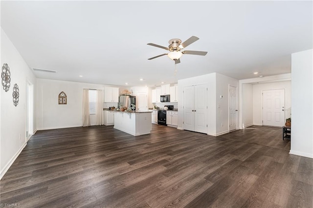 unfurnished living room with ceiling fan and dark hardwood / wood-style floors