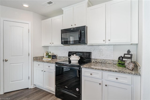 kitchen featuring tasteful backsplash, white cabinetry, black appliances, light stone countertops, and dark wood-type flooring