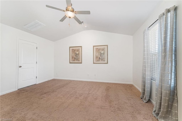 unfurnished room with ceiling fan, lofted ceiling, and carpet flooring