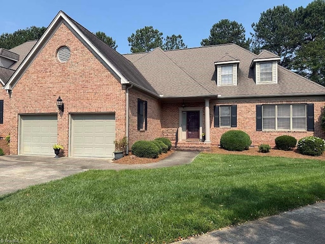 2014 Muirfield Ct, Elon, NC 27244 - view of front of home with driveway, a front lawn, brick siding, and a shingled roof