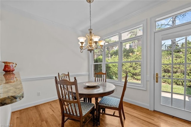2014 Muirfield Ct, Elon, NC 27244 - dining space featuring light wood finished floors, a chandelier, baseboards, and ornamental molding