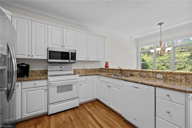 2014 Muirfield Ct, Elon, NC 27244 - kitchen with stainless steel appliances, a sink, ornamental molding, a chandelier, and white cabinetry
