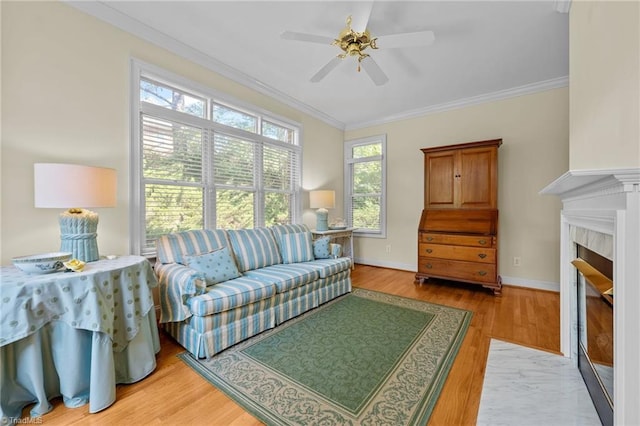 2014 Muirfield Ct, Elon, NC 27244 - living area with a ceiling fan, light wood finished floors, a tile fireplace, crown molding, and baseboards