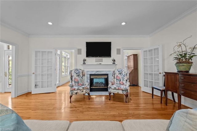 2014 Muirfield Ct, Elon, NC 27244 - living area with crown molding, a fireplace, wood finished floors, recessed lighting, and french doors