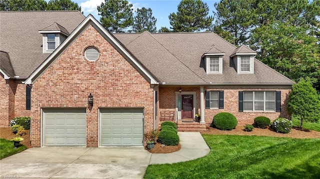 2014 Muirfield Ct, Elon, NC 27244 - view of front facade with driveway, an attached garage, brick siding, a front lawn, and roof with shingles