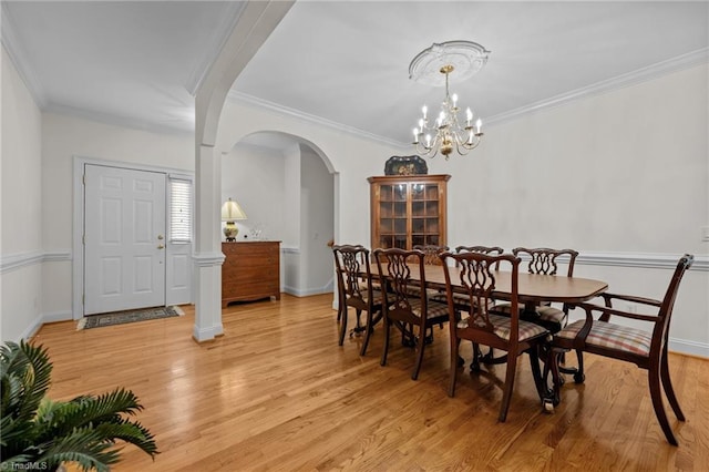 2014 Muirfield Ct, Elon, NC 27244 - dining room featuring arched walkways, ornamental molding, light wood finished floors, a chandelier, and baseboards