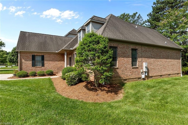 2014 Muirfield Ct, Elon, NC 27244 - view of home's exterior featuring brick siding, a lawn, roof with shingles, and crawl space