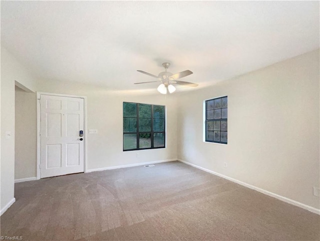 empty room featuring carpet and ceiling fan