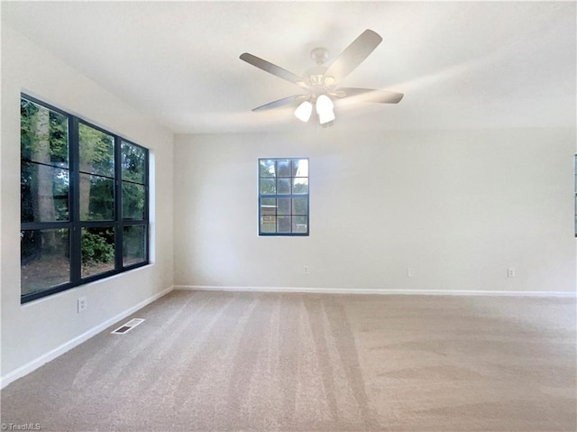 spare room with carpet and ceiling fan