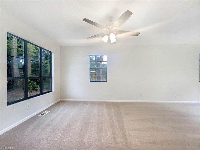 3877 Welcome Arcadia Rd, Lexington, NC 27295 - carpeted spare room featuring baseboards, a ceiling fan, visible vents, and a healthy amount of sunlight