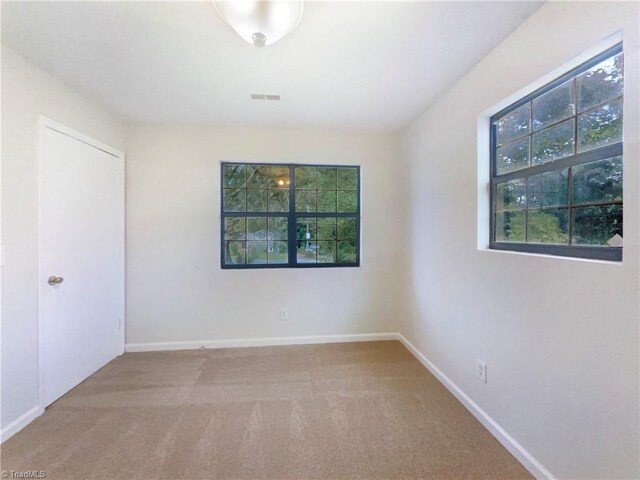 3877 Welcome Arcadia Rd, Lexington, NC 27295 - unfurnished room featuring carpet flooring, visible vents, and plenty of natural light