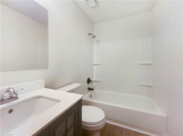 3877 Welcome Arcadia Rd, Lexington, NC 27295 - bathroom with wood finished floors, toilet, vanity, and bathing tub / shower combination