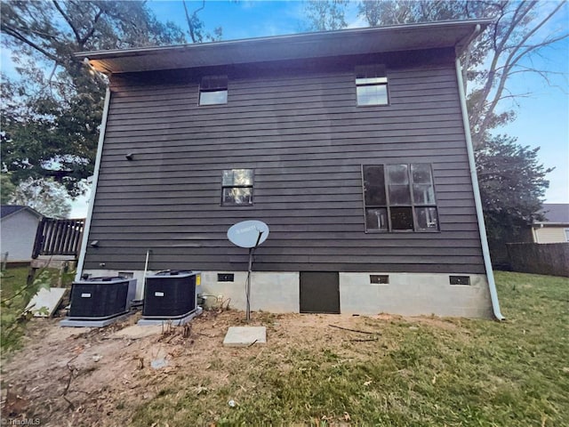 view of home's exterior featuring central AC and a lawn