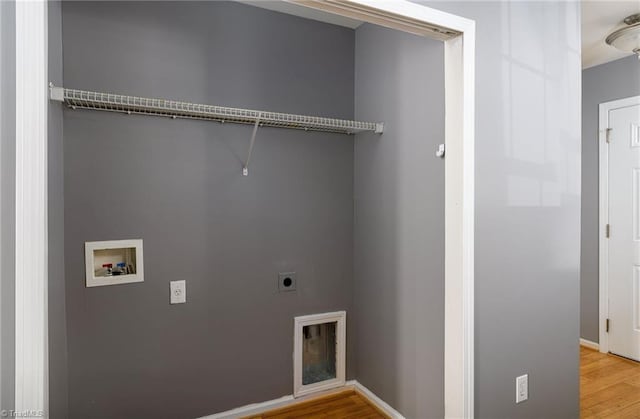 washroom with electric dryer hookup, washer hookup, and wood-type flooring