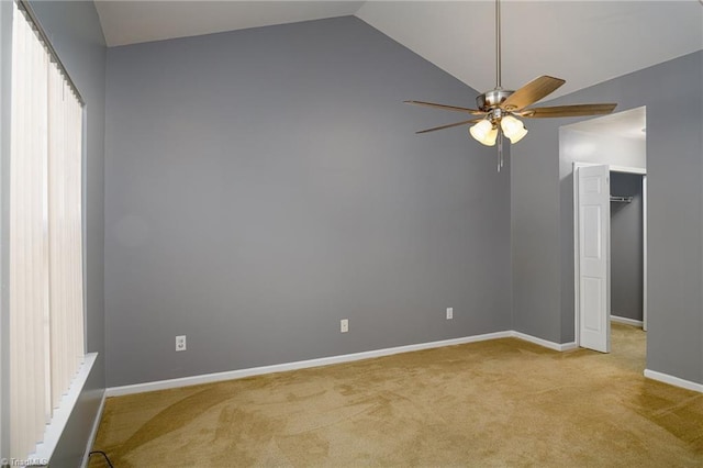 unfurnished room featuring ceiling fan, light colored carpet, and vaulted ceiling