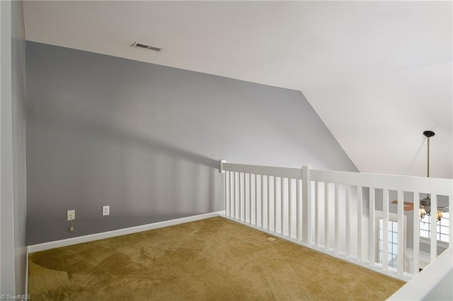 additional living space featuring lofted ceiling and carpet