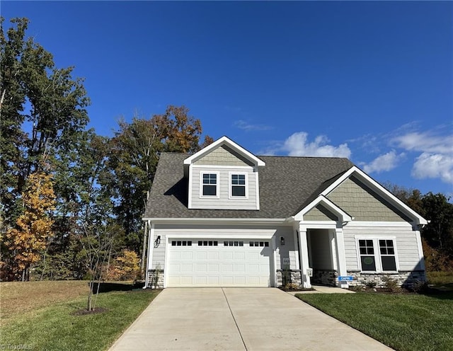 view of front of property featuring a garage and a front yard