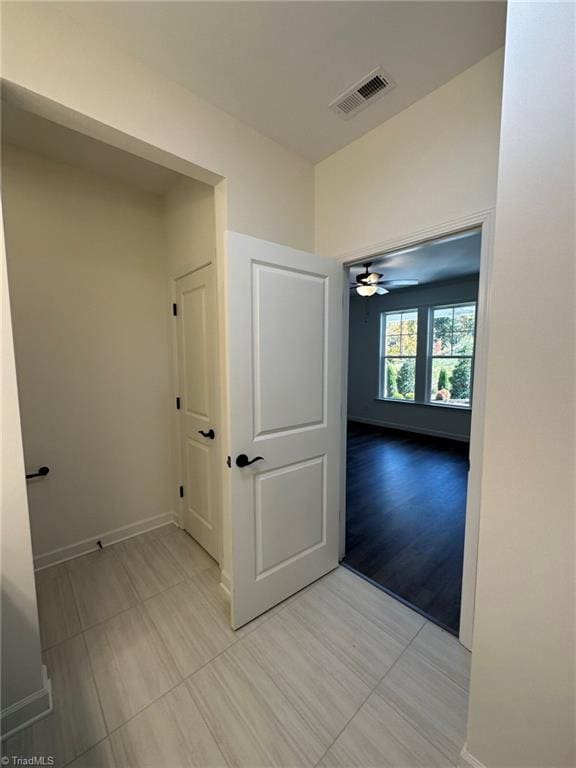 corridor with light hardwood / wood-style flooring