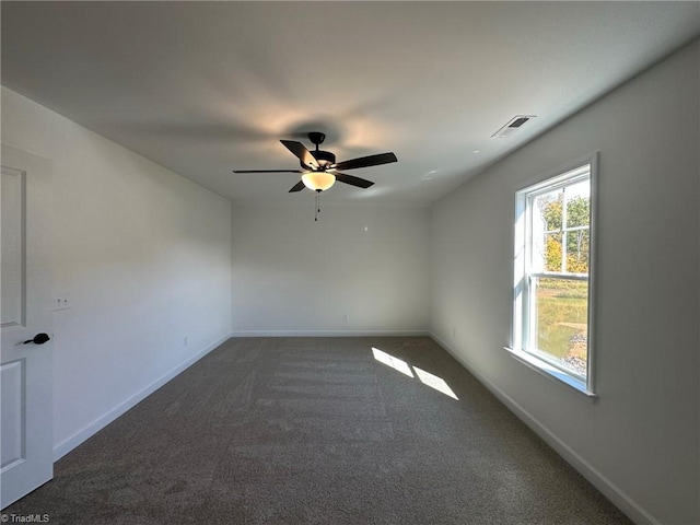 carpeted spare room featuring ceiling fan