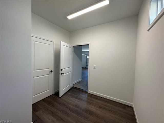 hall with dark hardwood / wood-style flooring