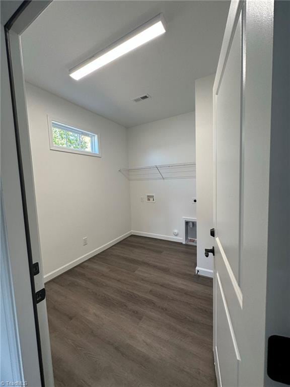 washroom with dark hardwood / wood-style floors and hookup for a washing machine